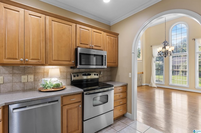 22582 Iron Masters Loop, Mccalla, AL 35111 - kitchen with appliances with stainless steel finishes, arched walkways, a chandelier, radiator, and light countertops