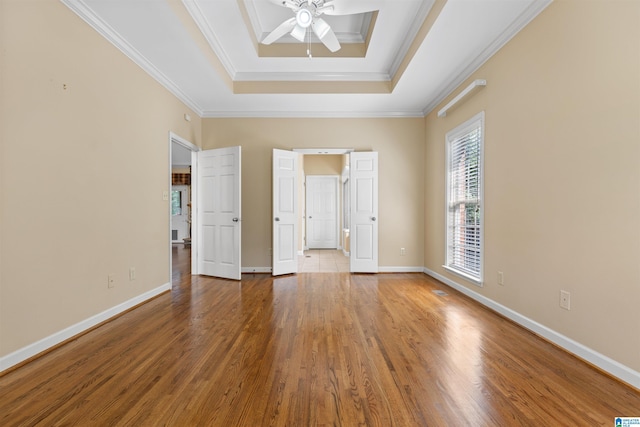 22582 Iron Masters Loop, Mccalla, AL 35111 - unfurnished bedroom featuring a tray ceiling, wood finished floors, baseboards, ornamental molding, and ensuite bath