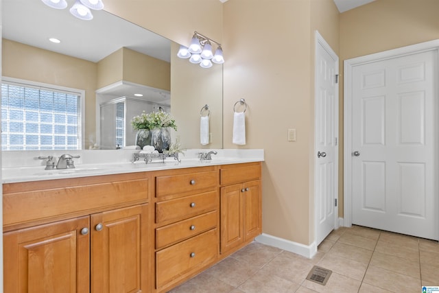 22582 Iron Masters Loop, Mccalla, AL 35111 - full bath featuring double vanity, a shower stall, tile patterned flooring, and baseboards