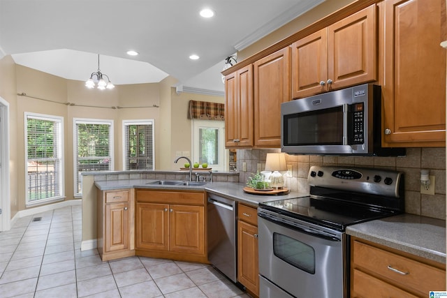 22582 Iron Masters Loop, Mccalla, AL 35111 - kitchen featuring stainless steel appliances, a sink, a peninsula, light tile patterned flooring, and backsplash