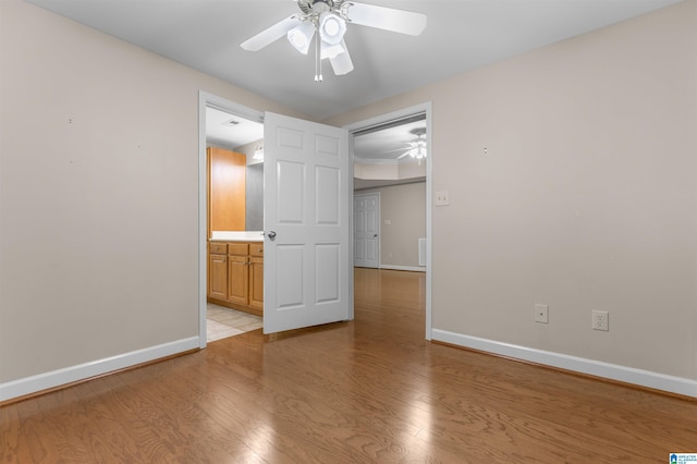 22582 Iron Masters Loop, Mccalla, AL 35111 - unfurnished bedroom with baseboards, light wood-style flooring, connected bathroom, and a ceiling fan