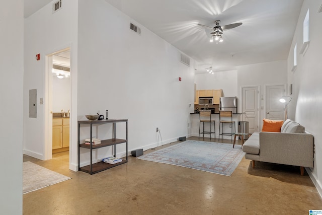 401 20th St S Unit 119, Birmingham, AL 35233 - living area with ceiling fan, finished concrete floors, electric panel, baseboards, and a high ceiling