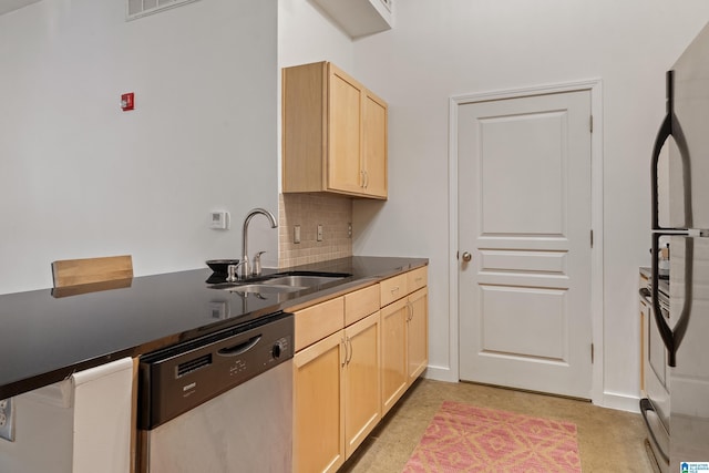 401 20th St S Unit 119, Birmingham, AL 35233 - kitchen featuring dishwasher, a sink, light brown cabinetry, decorative backsplash, and dark countertops