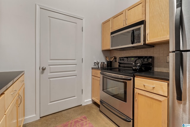 401 20th St S Unit 119, Birmingham, AL 35233 - kitchen with appliances with stainless steel finishes, light brown cabinets, dark countertops, decorative backsplash, and baseboards