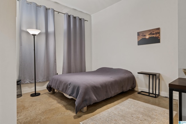 401 20th St S Unit 119, Birmingham, AL 35233 - bedroom with baseboards and concrete flooring