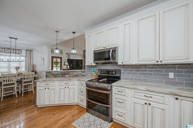 325 Driving Range Rd, Cropwell, AL 35054 - kitchen with appliances with stainless steel finishes, backsplash, a peninsula, and light wood finished floors