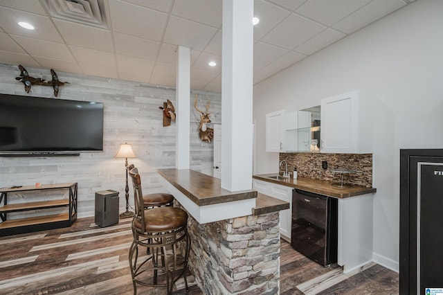 325 Driving Range Rd, Cropwell, AL 35054 - indoor bar featuring wine cooler, dark wood finished floors, tasteful backsplash, wood walls, and recessed lighting