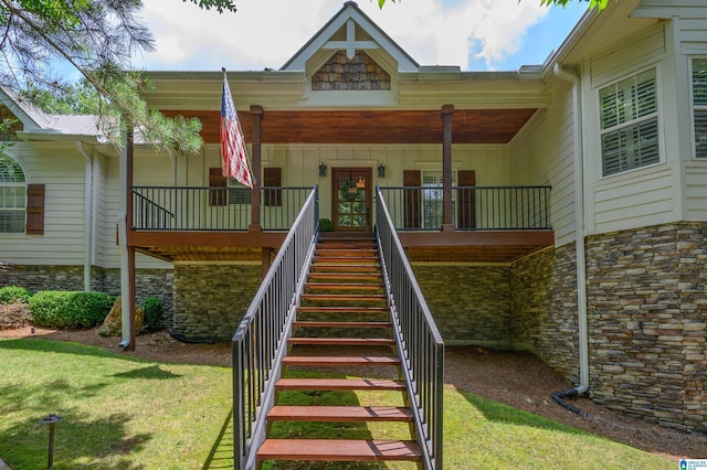 325 Driving Range Rd, Cropwell, AL 35054 - view of exterior entry with stone siding, a yard, and board and batten siding