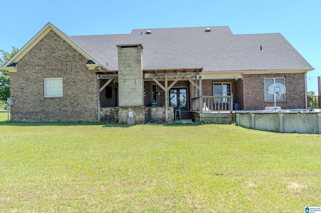 178 Jerry Marsh Rd, Locust Fork, AL 35097 - rear view of property with brick siding, a yard, roof with shingles, and a covered pool