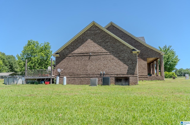 178 Jerry Marsh Rd, Locust Fork, AL 35097 - view of home's exterior featuring a lawn, brick siding, central AC unit, and a wooden deck
