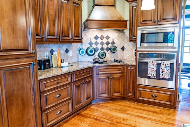 178 Jerry Marsh Rd, Locust Fork, AL 35097 - kitchen featuring stainless steel appliances, premium range hood, tasteful backsplash, and light wood finished floors
