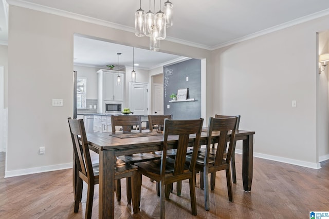 5182 Park Side Cir, Hoover, AL 35244 - dining room featuring wood finished floors, crown molding, and a chandelier