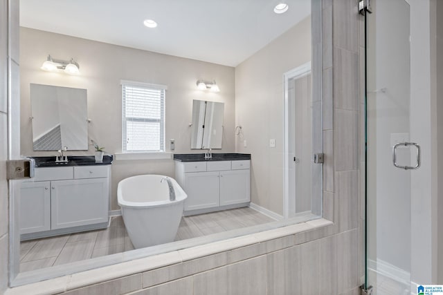 5182 Park Side Cir, Hoover, AL 35244 - bathroom with a stall shower, two vanities, a soaking tub, and recessed lighting