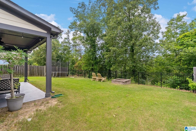 5182 Park Side Cir, Hoover, AL 35244 - fenced backyard featuring a patio area and a trampoline