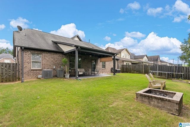 5182 Park Side Cir, Hoover, AL 35244 - rear view of property with a fire pit, brick siding, a patio, a trampoline, and a fenced backyard