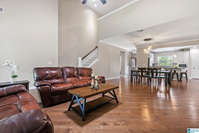5182 Park Side Cir, Hoover, AL 35244 - living room with ornamental molding, ceiling fan, wood finished floors, stairs, and a high ceiling