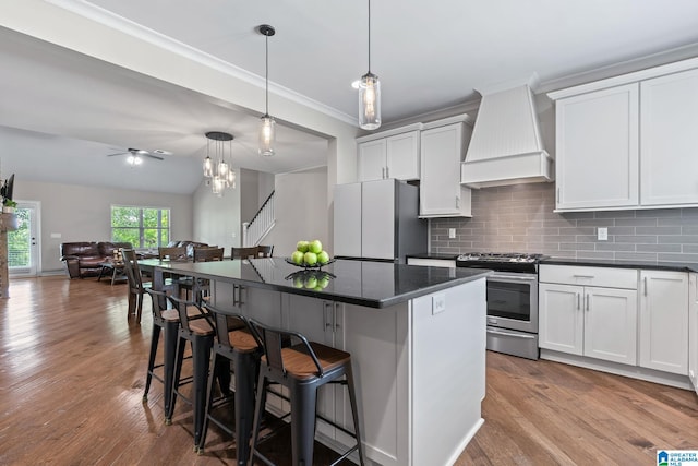 5182 Park Side Cir, Hoover, AL 35244 - kitchen with stainless steel range with gas cooktop, custom range hood, freestanding refrigerator, a breakfast bar area, and crown molding