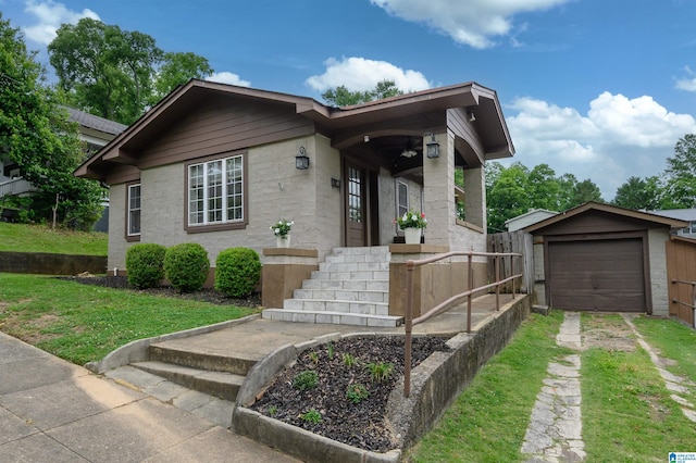 1319 17th St S, Birmingham, AL 35205 - single story home with driveway, a front lawn, a garage, and an outbuilding