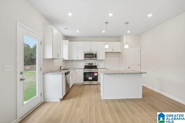 2029 Valley Run, Leeds, AL 35094 - kitchen with stainless steel appliances, white cabinets, light wood-type flooring, light stone counters, and tasteful backsplash