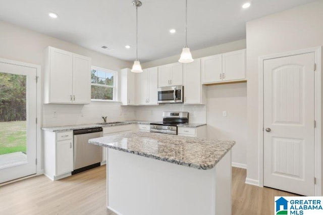 2029 Valley Run, Leeds, AL 35094 - kitchen featuring stainless steel appliances, backsplash, white cabinetry, light wood-type flooring, and light stone countertops