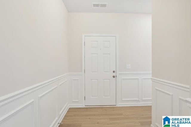 2029 Valley Run, Leeds, AL 35094 - doorway to outside with a decorative wall, light wood-style flooring, and wainscoting