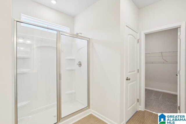 2029 Valley Run, Leeds, AL 35094 - bathroom with a shower stall, a walk in closet, and baseboards