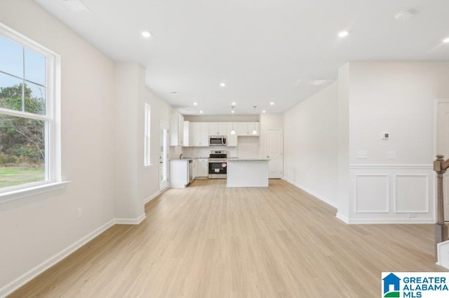 2029 Valley Run, Leeds, AL 35094 - unfurnished living room featuring light wood-style flooring, plenty of natural light, baseboards, and recessed lighting