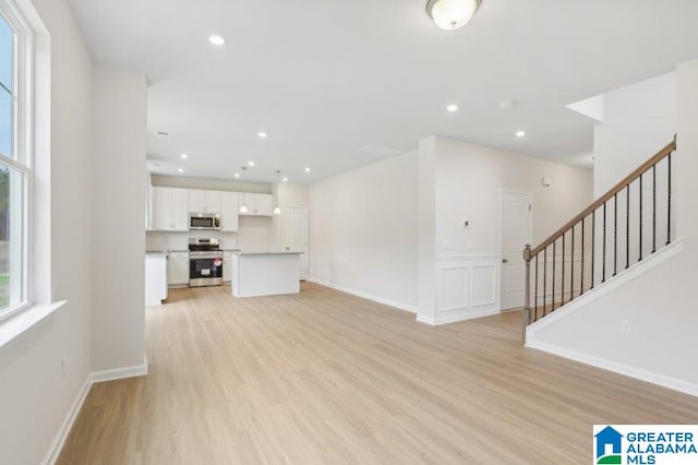2029 Valley Run, Leeds, AL 35094 - unfurnished living room featuring light wood-type flooring, stairs, recessed lighting, and baseboards