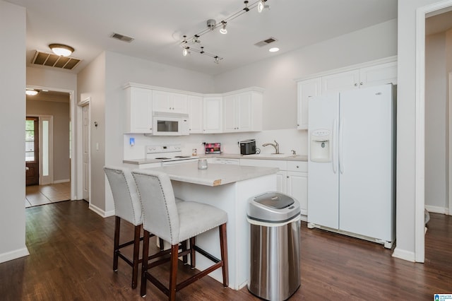 1166 Eagle Dr, Maylene, AL 35114 - kitchen featuring white appliances, light countertops, white cabinetry, and a kitchen breakfast bar