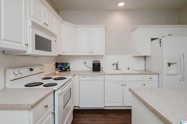1166 Eagle Dr, Maylene, AL 35114 - kitchen featuring white appliances, light countertops, white cabinets, dark wood finished floors, and backsplash