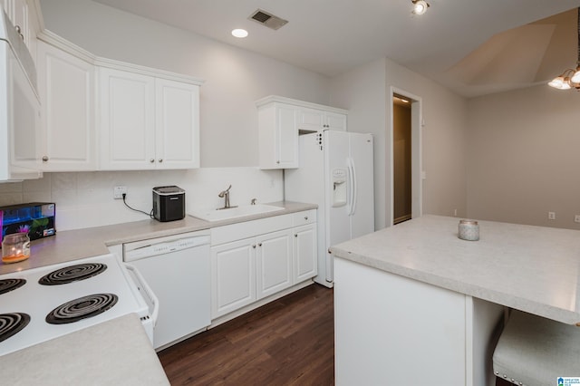 1166 Eagle Dr, Maylene, AL 35114 - kitchen featuring white appliances, dark wood-type flooring, backsplash, white cabinets, and light countertops