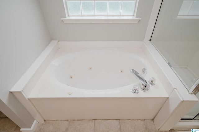 1166 Eagle Dr, Maylene, AL 35114 - bathroom with plenty of natural light, a jetted tub, and tile patterned flooring