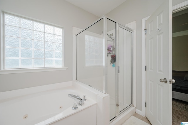 1166 Eagle Dr, Maylene, AL 35114 - bathroom with a tub with jets, a stall shower, connected bathroom, and tile patterned flooring