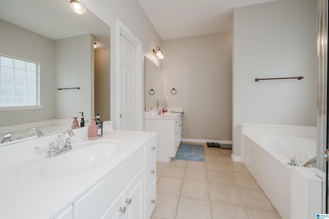 1166 Eagle Dr, Maylene, AL 35114 - bathroom with two vanities, a bath, and tile patterned flooring