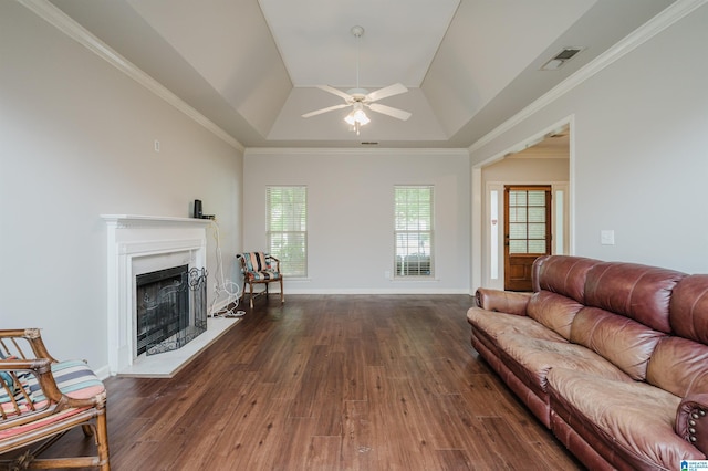 1166 Eagle Dr, Maylene, AL 35114 - living area with a raised ceiling, ceiling fan, dark wood-style flooring, a fireplace with raised hearth, and ornamental molding