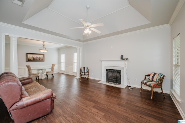 1166 Eagle Dr, Maylene, AL 35114 - living area with ornate columns, a ceiling fan, dark wood-style flooring, a fireplace, and crown molding