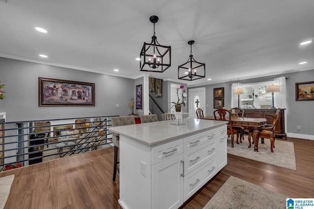 3303 Carousel Dr, Fultondale, AL 35068 - kitchen featuring a kitchen breakfast bar, white cabinets, pendant lighting, recessed lighting, and dark wood-type flooring