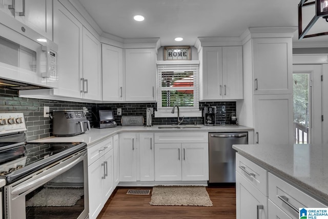 3303 Carousel Dr, Fultondale, AL 35068 - kitchen featuring appliances with stainless steel finishes, healthy amount of natural light, white cabinetry, and recessed lighting