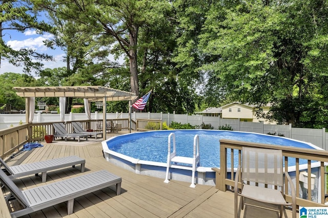 3303 Carousel Dr, Fultondale, AL 35068 - view of swimming pool featuring a wooden deck, a fenced backyard, a pergola, and view of scattered trees
