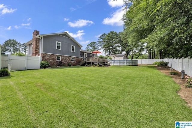3303 Carousel Dr, Fultondale, AL 35068 - fenced backyard featuring a wooden deck and stairs
