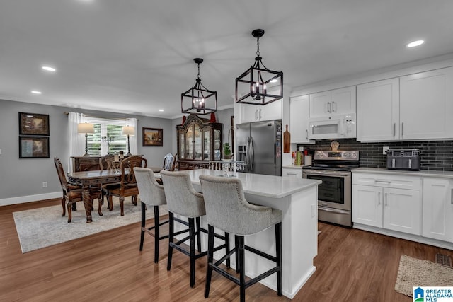 3303 Carousel Dr, Fultondale, AL 35068 - kitchen with appliances with stainless steel finishes, light countertops, white cabinetry, recessed lighting, and tasteful backsplash