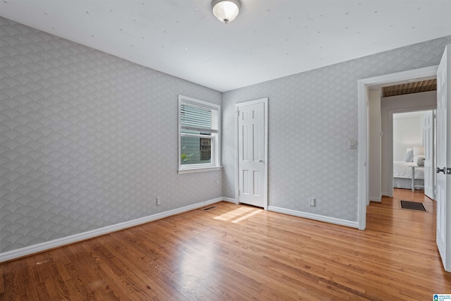 326 Lathrop Ave, Homewood, AL 35209 - unfurnished bedroom with light wood-style flooring and wallpapered walls