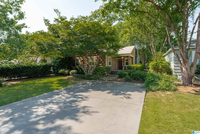 326 Lathrop Ave, Homewood, AL 35209 - view of property hidden behind natural elements featuring a chimney, a front lawn, and covered porch