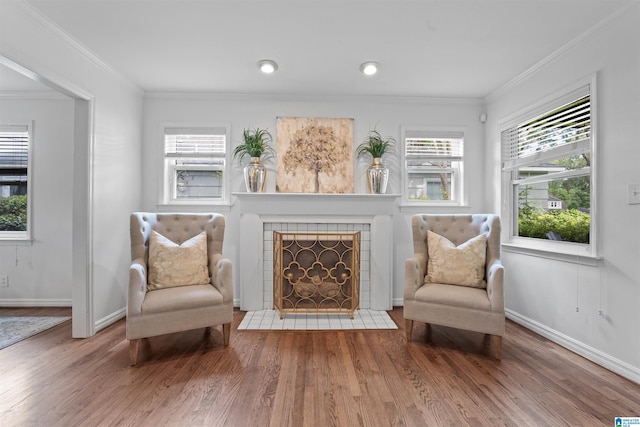 326 Lathrop Ave, Homewood, AL 35209 - living area featuring wood finished floors, crown molding, healthy amount of natural light, and a fireplace
