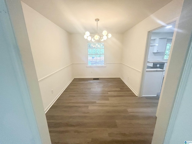 3583 Valley Cir, Vestavia Hills, AL 35243 - unfurnished dining area featuring dark wood finished floors, plenty of natural light, and a chandelier