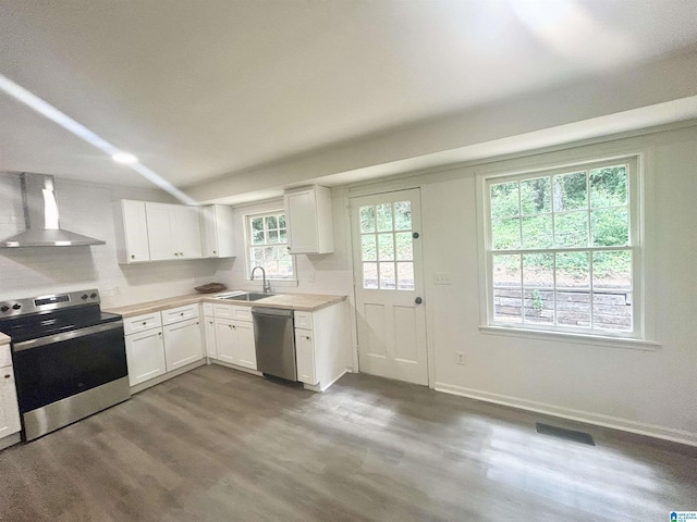 3583 Valley Cir, Vestavia Hills, AL 35243 - kitchen featuring appliances with stainless steel finishes, wall chimney range hood, dark wood-style flooring, light countertops, and white cabinetry