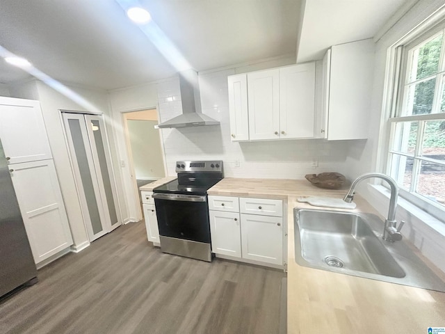 3583 Valley Cir, Vestavia Hills, AL 35243 - kitchen featuring electric stove, wall chimney range hood, wood finished floors, white cabinetry, and tasteful backsplash
