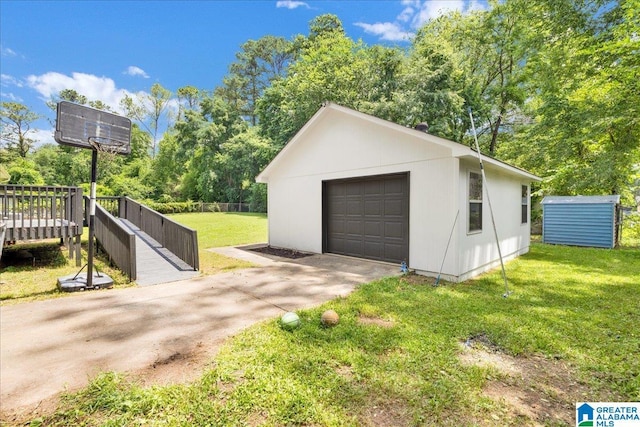 2009 Palmer Ave, Leeds, AL 35094 - detached garage featuring driveway and view of scattered trees