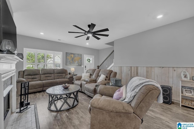 1515 Baxter Ave, Springville, AL 35146 - living area featuring a fireplace with flush hearth, a ceiling fan, wood finished floors, recessed lighting, and stairway