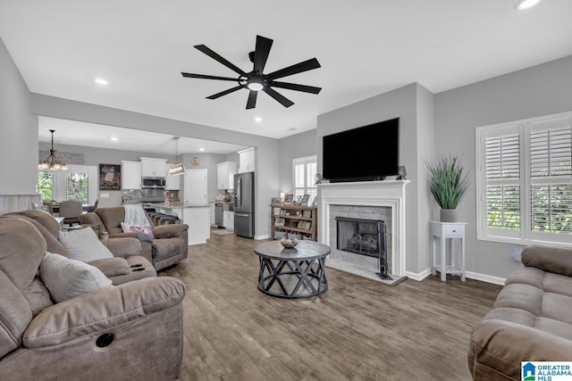 1515 Baxter Ave, Springville, AL 35146 - living area featuring wood finished floors, ceiling fan, healthy amount of natural light, and recessed lighting